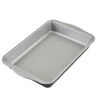 Silver rectangular baking pan with Mickey Mouse-shaped indentations.