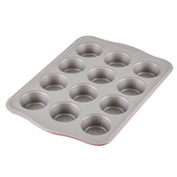 A 12-cup metal muffin baking tray on a white background.