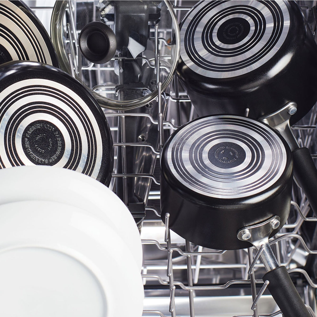 Pots, pans, and plates loaded inside a dishwasher.