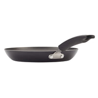 Non-stick frying pan with a black handle, viewed from the side.