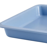 Close-up of a blue rectangular baking pan's corner in a smooth finish.
