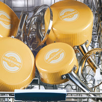Yellow Farberware pots arranged in a dishwasher rack.