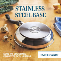 Stainless steel pan with a handle on a wooden surface near garlic and herbs.