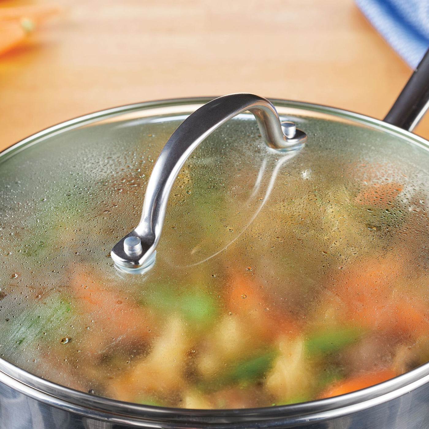 The Millennium Stainless Steel 10-Piece Cookware Set, known for its excellent heat distribution, includes a piece shown steaming vegetables from above.
