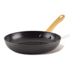 The Forged Induction Ceramic 10-Inch Frying Pan features a nonstick ceramic surface, suitable for induction cooking, and is crafted with durable forged aluminum construction, complemented by a wooden handle.
