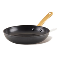 The Forged Induction Ceramic 10-Inch Frying Pan features a nonstick ceramic surface, suitable for induction cooking, and is crafted with durable forged aluminum construction, complemented by a wooden handle.