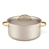 The Radiant Nonstick 5.5-Quart Dutch Oven with Lid, featuring a luxurious silver finish and gold handles, ensures excellent heat distribution, making it an essential kitchen tool.