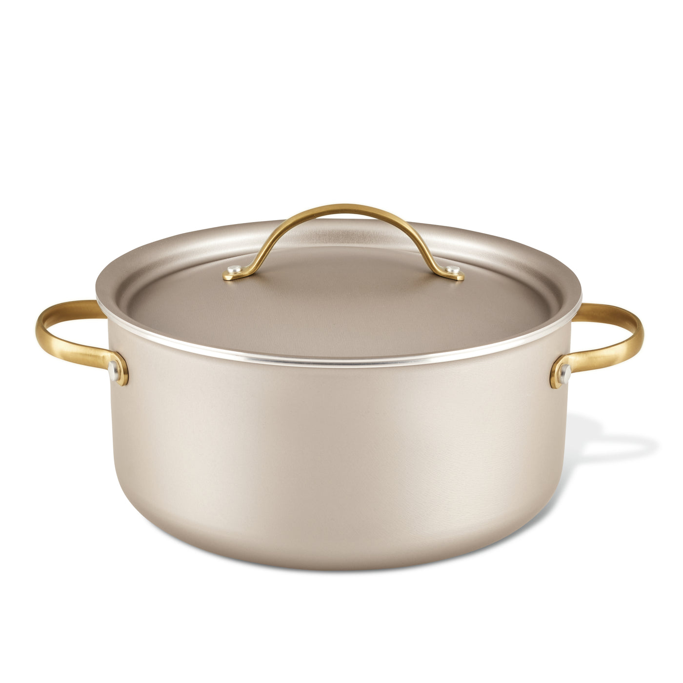 The Radiant Nonstick 5.5-Quart Dutch Oven with Lid, featuring a luxurious silver finish and gold handles, ensures excellent heat distribution, making it an essential kitchen tool.