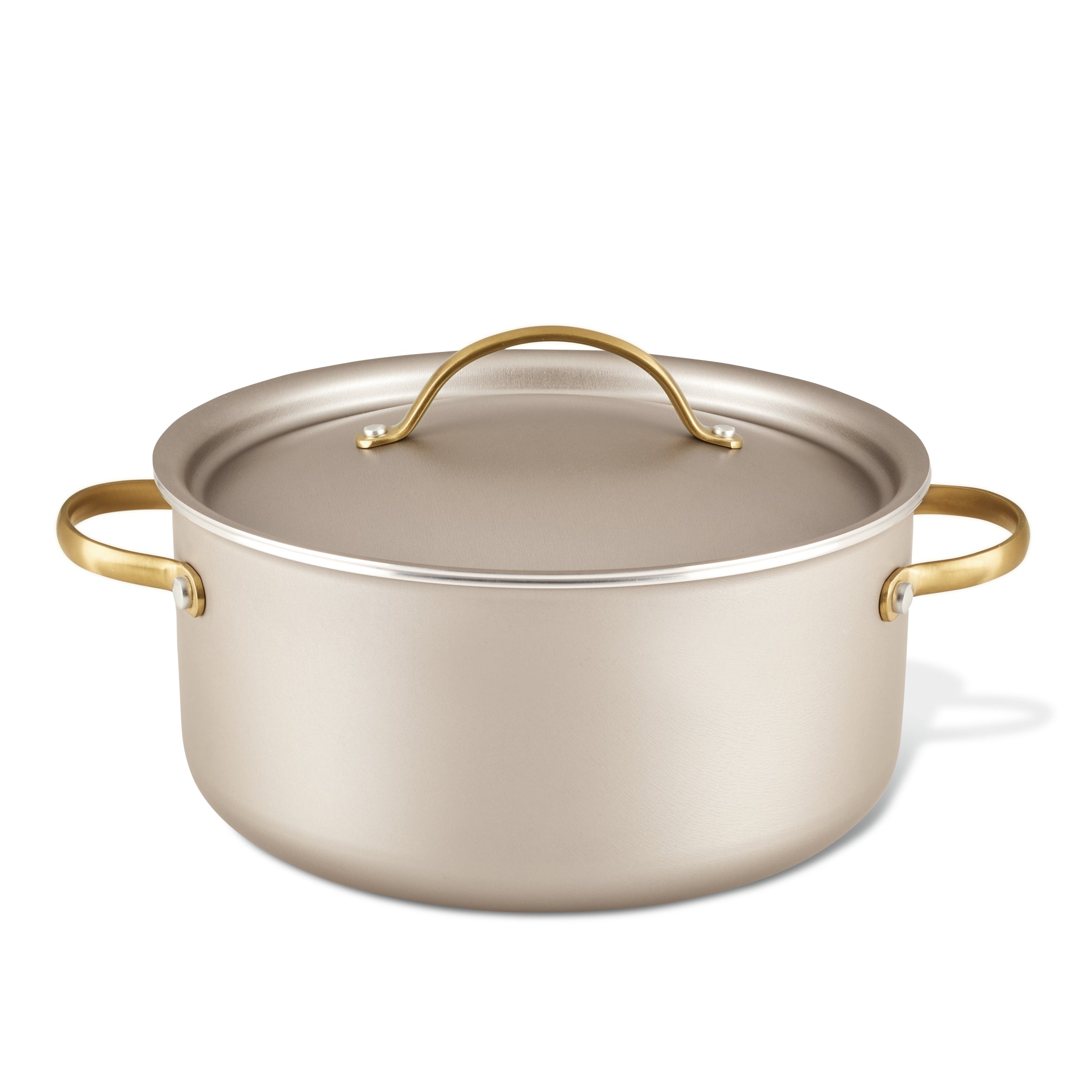 The Radiant Nonstick 5.5-Quart Dutch Oven with Lid, featuring a luxurious silver finish and gold handles, ensures excellent heat distribution, making it an essential kitchen tool.
