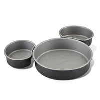Three round cake pans of different sizes placed next to each other.
