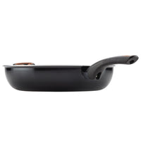 Black frying pan with a long handle viewed from the side.