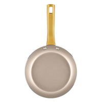 A top view of the Radiant Nonstick Frying Pan reveals a champagne-colored surface and a gold handle, making it ideal for even heat distribution.