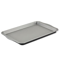 This 10" x 15" Nonstick Cookie Pan, featuring raised edges and designed to meet all your bakeware needs, is set against a white background.