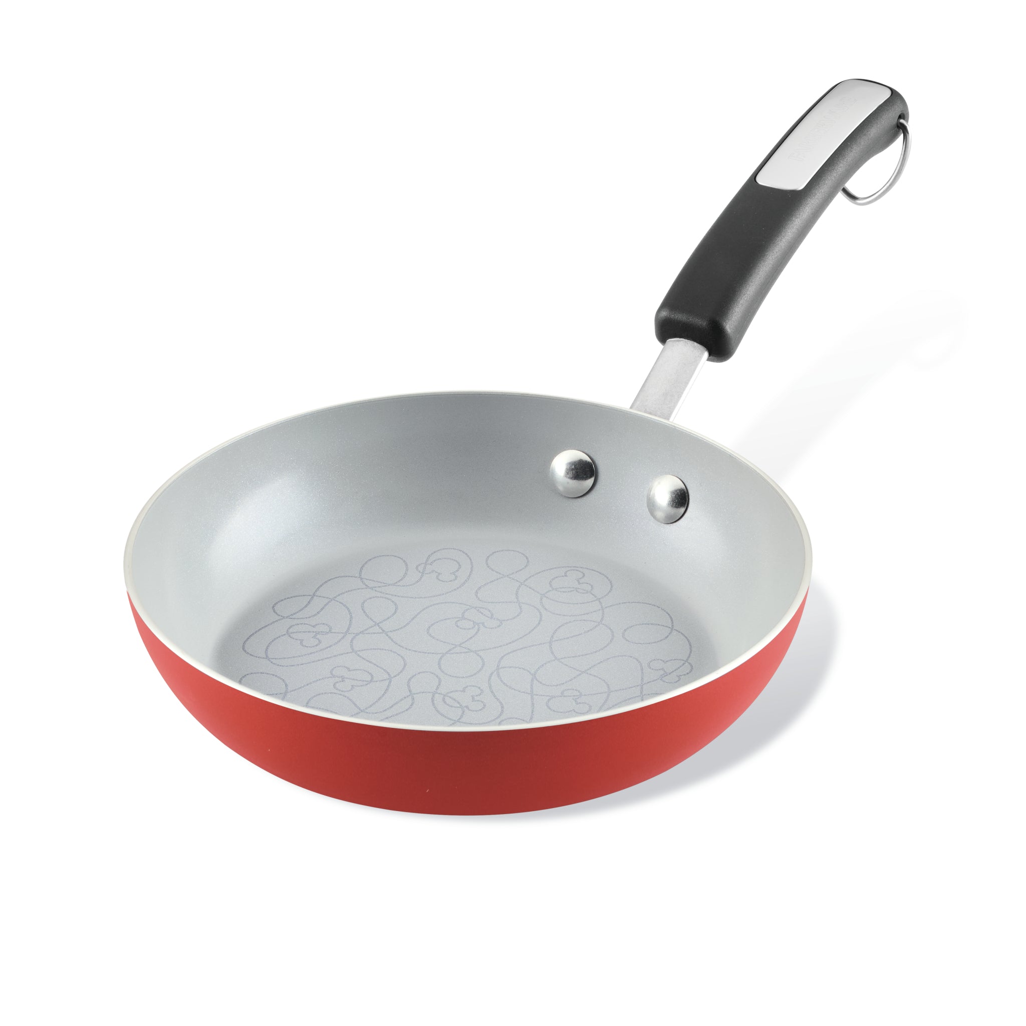 Bon Voyage frying pan featuring a red exterior, a black handle, and a ceramic nonstick interior.