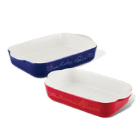 A set of two ceramic baking dishes in blue and red, featuring decorative writing and inspired by the Disney Mickey Mouse Bon Voyage collection.