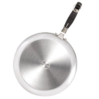 Bottom view of a stainless steel frying pan with a black handle.