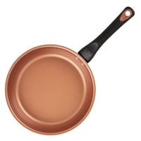 Copper nonstick frying pan with a black handle, viewed from above.