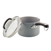The 3-Quart Recycled Aluminum Nonstick Straining Saucepan is designed with a stylish gray finish, complete with a glass lid and a sleek black handle.