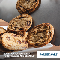Chocolate chip cookies on a tilted, heavy-gauge steel nonstick round cake pan from a 2-Piece Nonstick Round Cake Pan Set.