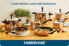 Assorted Farberware cookware is displayed on a wooden countertop, making it the ideal gift for any culinary enthusiast. Consider pairing it with the Farberware Digital Gift Card, which is easily redeemable at checkout.