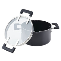 The 6-Quart Nonstick Straining Saucepot in black, with a glass lid, boasts sturdy black handles and is equipped with DiamondMax nonstick coating for easy cooking and cleaning.