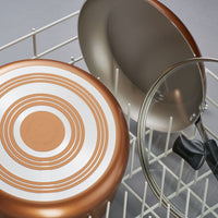 A 15-Piece Nonstick Cookware Set with copper-bottom pans and a glass lid rests in a dish rack, showcasing heavy gauge aluminum for superior durability.