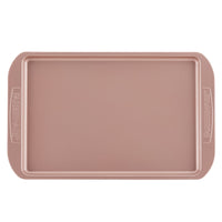The Cookie Pan is a rectangular baking sheet featuring handles on both sides and a nonstick surface, making it perfect for baking cookies and ensuring easy cleanup.
