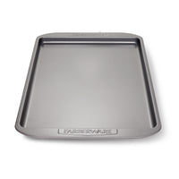 Cookie Pan by Farberware, a nonstick rectangular baking sheet featuring raised edges, ideal for baking cookies, set against a white background.