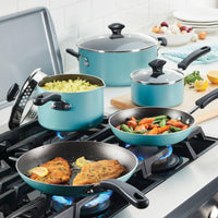 A blue Nonstick Frying Pan Set on the stove with chicken, rice, and vegetables sizzling inside.