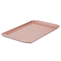 A rose gold Cookie Pan gracefully sits on a pristine white background, ready to perfectly bake your favorite cookies.