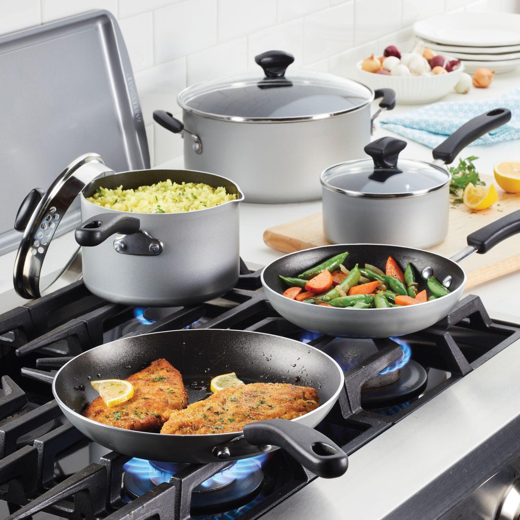On the stove, the Nonstick Saucepan with Straining Lid showcases its DiamondMax nonstick technology, flawlessly cooking vegetables, rice, and breaded fish with precision.