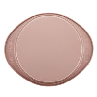 Rose gold, round-shaped 9-inch cake pan with raised edges, featuring a durable nonstick surface for easy cleanup.
