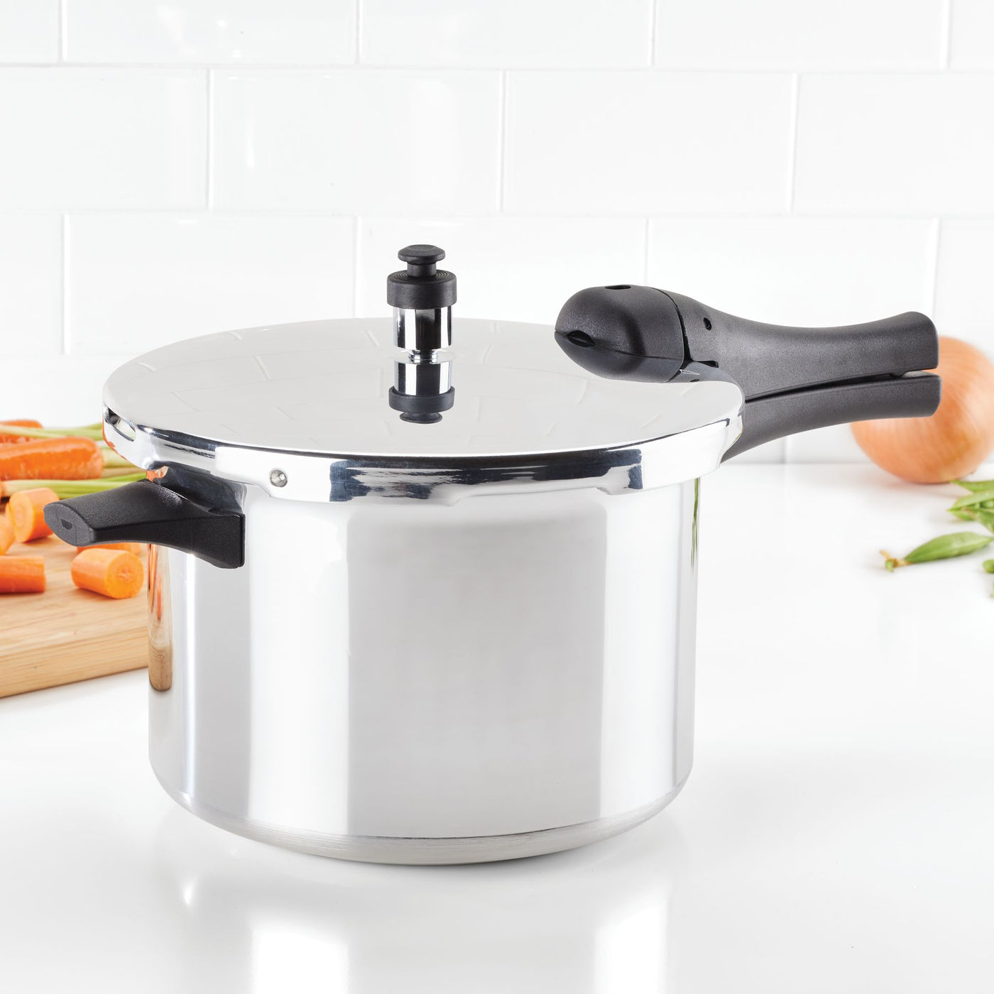 A 6-Quart Stovetop Pressure Cooker sits elegantly on a kitchen counter, ready for some stovetop cooking, surrounded by fresh vegetables waiting to be transformed.