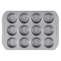 A top-down view of a silver-finished Muffin Pan, designed for baking 12 blueberry muffins.