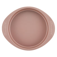 The 9-Inch Round Cake Pan in rose gold features side handles and embossed "Farberware" text, designed for easy cleanup and durability.