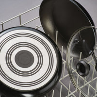 The Nonstick Frying Pan is placed in the dishwasher rack alongside its lid, highlighting its durable aluminum construction that guarantees effortless cleaning and lasting durability.