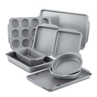 The 10-Piece Nonstick Bakeware Set, featuring assorted gray baking pans and trays with a nonstick coating for effortless food release, is neatly arranged on a white background.