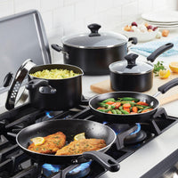 Four pans, one of which is an 11-Inch Nonstick Square Griddle, are cooking various foods on a stove in a kitchen setting, ensuring easy food release for perfectly prepared meals.