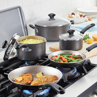 A variety of cookware, including the 12.25-Inch Nonstick Wok ideal for stir fries, complements both the gas stove and kitchen counter beautifully with food.