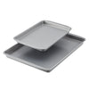 A 2-Piece Nonstick Sheet Pan Set, featuring two stacked heavy-gauge steel baking trays in gray, on a white background.